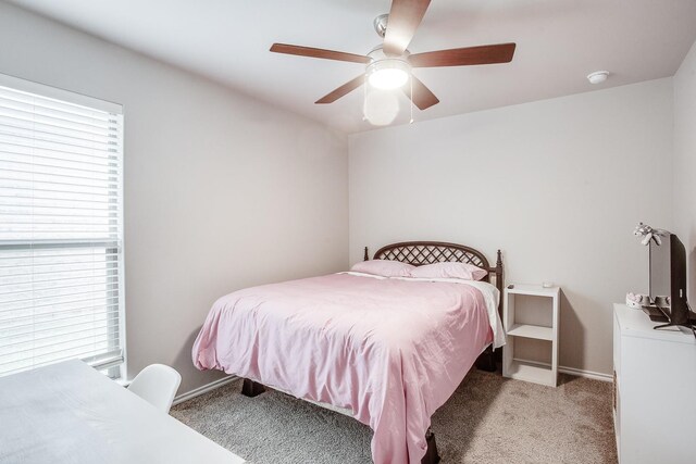 carpeted bedroom featuring ceiling fan