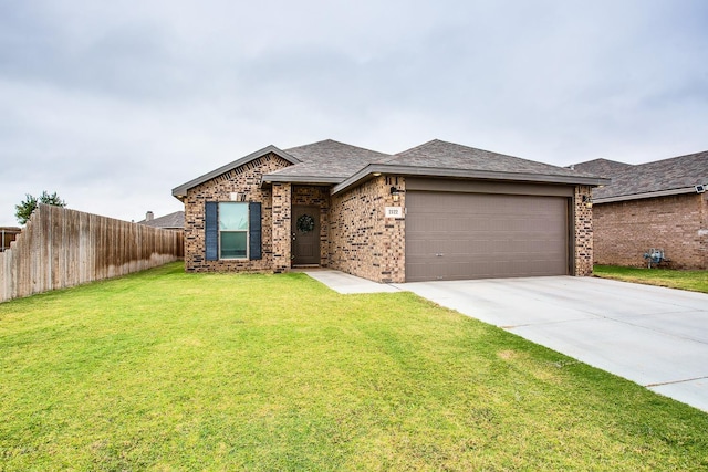 view of front of home featuring a garage and a front lawn