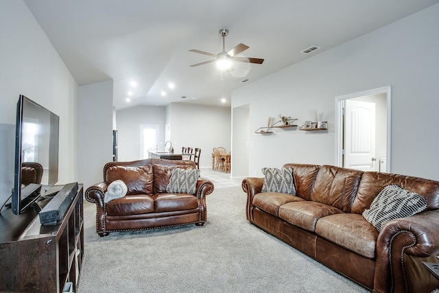 living room with ceiling fan, light colored carpet, and lofted ceiling