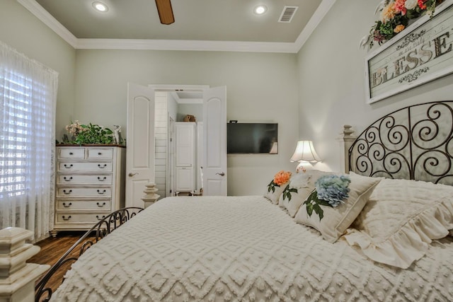 bedroom featuring ornamental molding, wood-type flooring, and ceiling fan