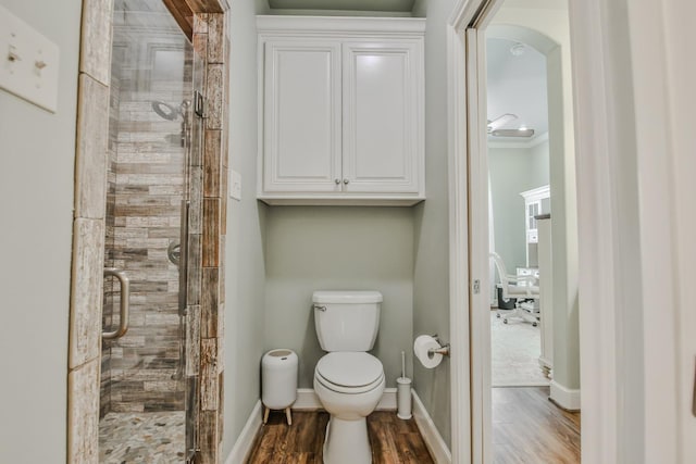 bathroom with walk in shower, wood-type flooring, and toilet