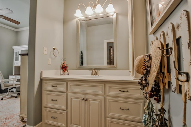 bathroom with crown molding, ceiling fan, and vanity