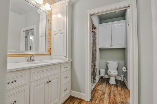 bathroom featuring vanity, hardwood / wood-style floors, and toilet