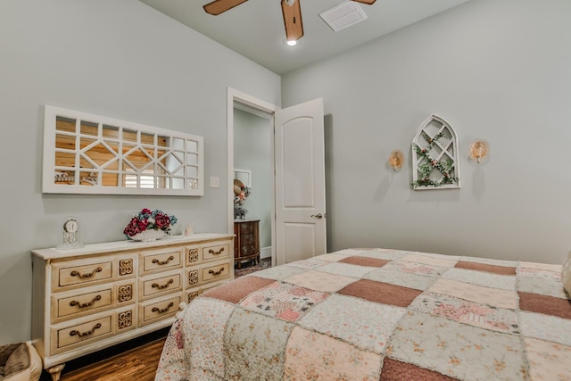 bedroom with ceiling fan and dark hardwood / wood-style flooring