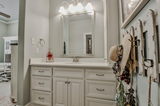 bathroom featuring crown molding, vanity, and a notable chandelier