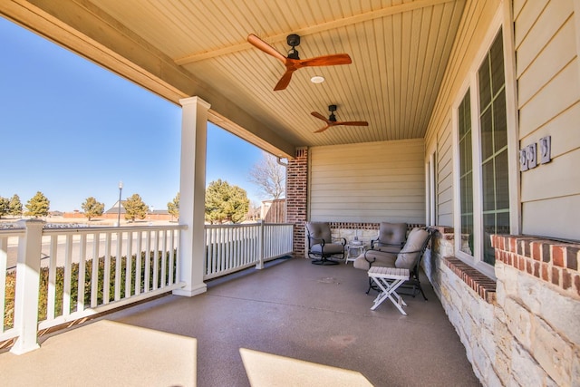 view of patio featuring ceiling fan and a porch