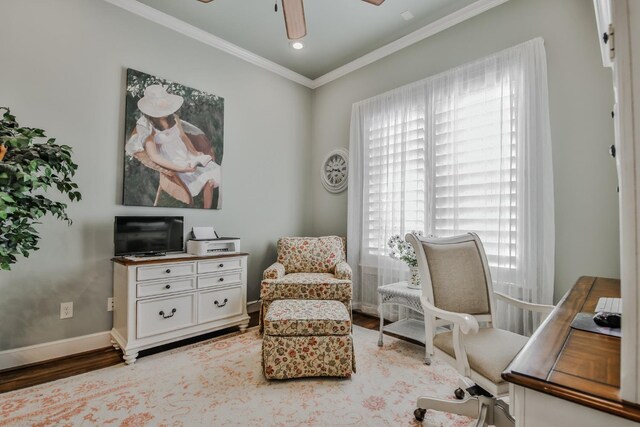 sitting room with hardwood / wood-style floors, ornamental molding, and ceiling fan