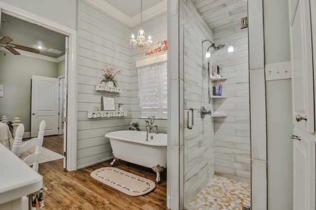 bathroom with independent shower and bath, ornamental molding, ceiling fan with notable chandelier, and hardwood / wood-style floors