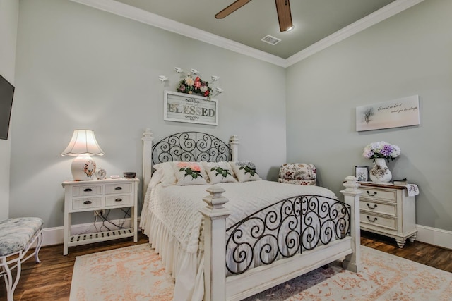 bedroom featuring crown molding, dark hardwood / wood-style floors, and ceiling fan