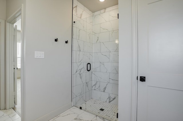 bathroom featuring a shower with shower door