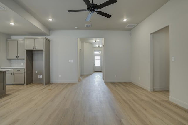 unfurnished living room featuring ceiling fan and light hardwood / wood-style floors