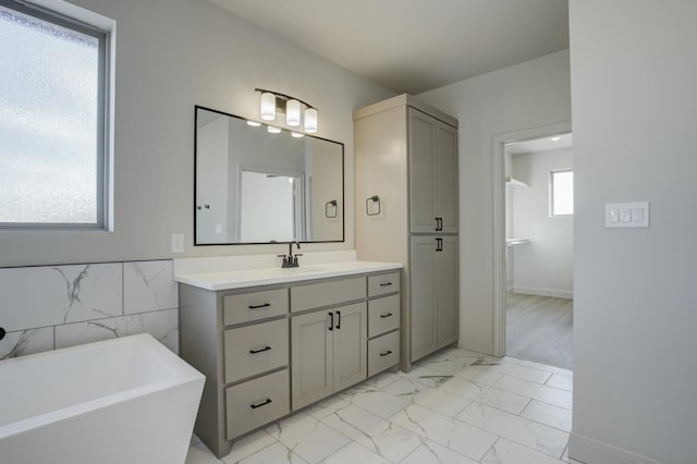 bathroom with vanity and a tub