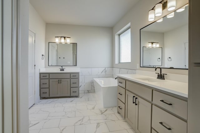 bathroom with vanity, a bathing tub, and tile walls