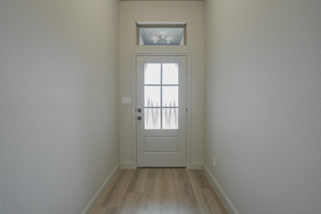 doorway to outside with light wood-type flooring