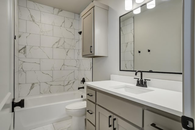 full bathroom featuring tiled shower / bath, vanity, and toilet