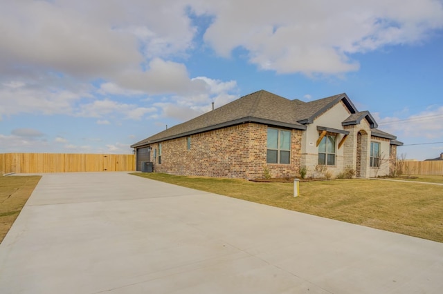 view of property exterior featuring central AC and a lawn