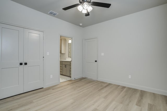 unfurnished bedroom with ceiling fan, connected bathroom, a closet, and light wood-type flooring