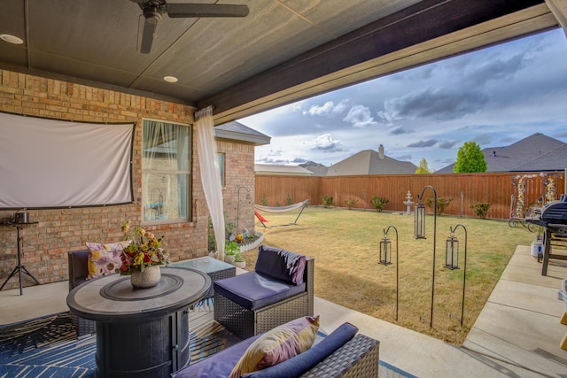 view of patio / terrace featuring an outdoor living space, a fenced backyard, and a ceiling fan