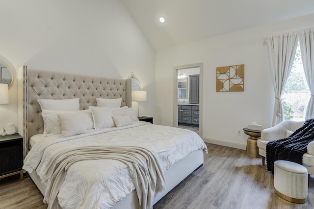 bedroom featuring baseboards, high vaulted ceiling, wood finished floors, and recessed lighting