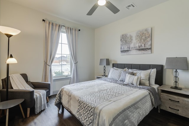 bedroom featuring visible vents, ceiling fan, and dark wood-type flooring