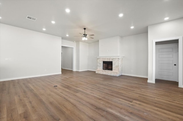 1204 E 31st St, Wolfforth, TX 79382 - unfurnished living room featuring ceiling fan, dark hardwood / wood-style floors, and a fireplace
