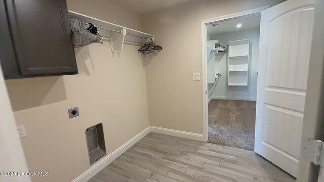 7501 100th St, Lubbock, TX 79424 - washroom with cabinet space, electric dryer hookup, and light wood finished floors