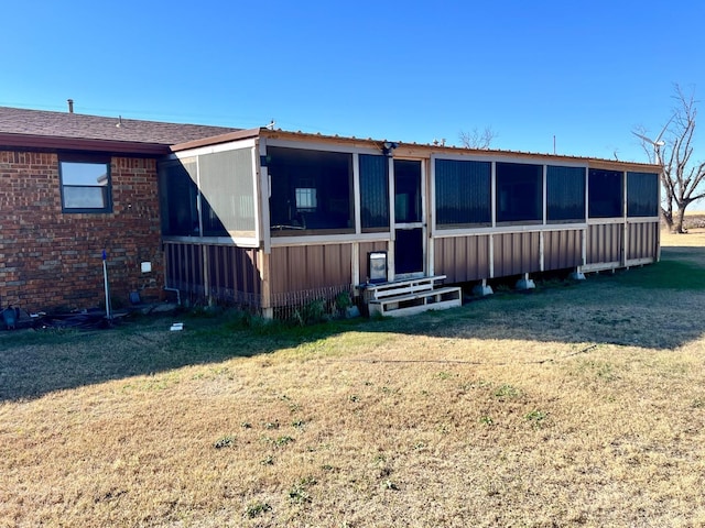 back of property with a lawn
