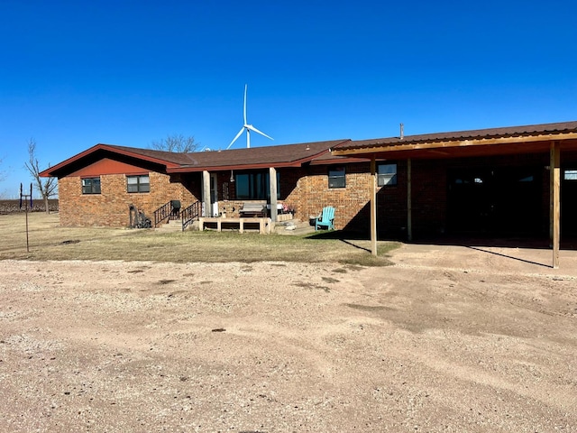 rear view of property with a carport