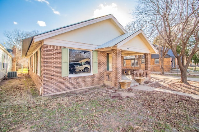 bungalow-style house featuring central AC unit