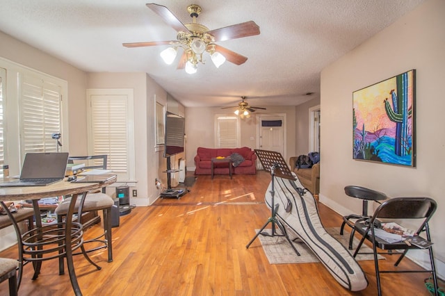 exercise room with hardwood / wood-style flooring and a textured ceiling