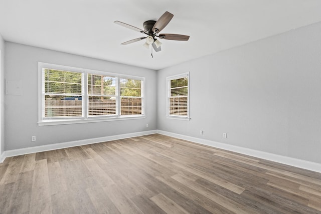 empty room featuring hardwood / wood-style floors and ceiling fan