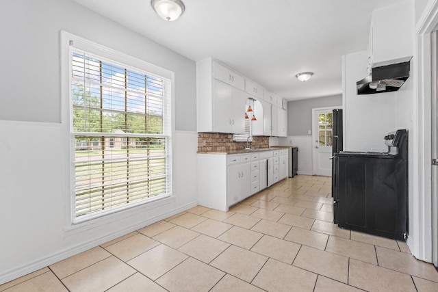 kitchen featuring white cabinetry, light tile patterned floors, tasteful backsplash, and sink