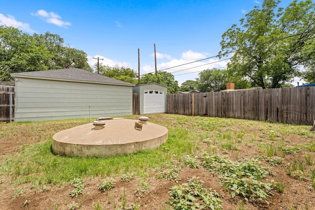 view of yard with a garage and an outdoor structure