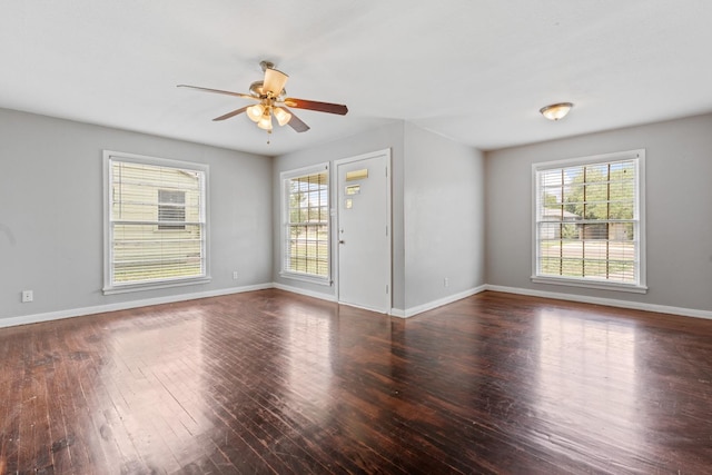 unfurnished room featuring dark wood-type flooring and ceiling fan