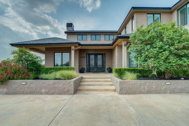 view of exterior entry featuring french doors