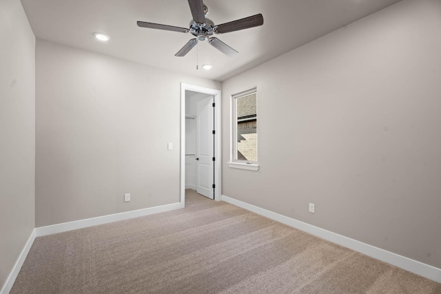 carpeted empty room with ceiling fan