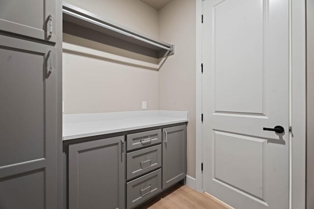 laundry room with light wood-type flooring