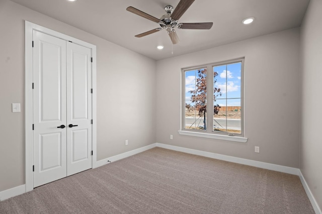 empty room featuring light carpet and ceiling fan