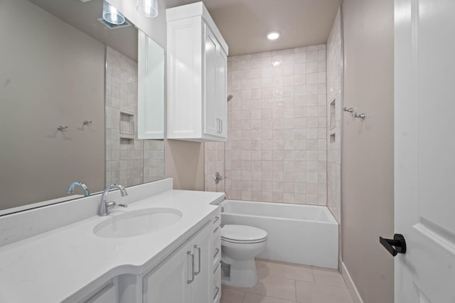 full bathroom with tile patterned flooring, vanity, tiled shower / bath combo, and toilet