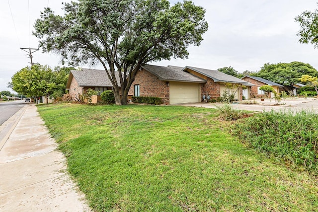 single story home with a garage and a front lawn