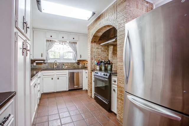 5411 89th St, Lubbock, TX 79424 - kitchen featuring appliances with stainless steel finishes, a sink, dark countertops, and decorative backsplash