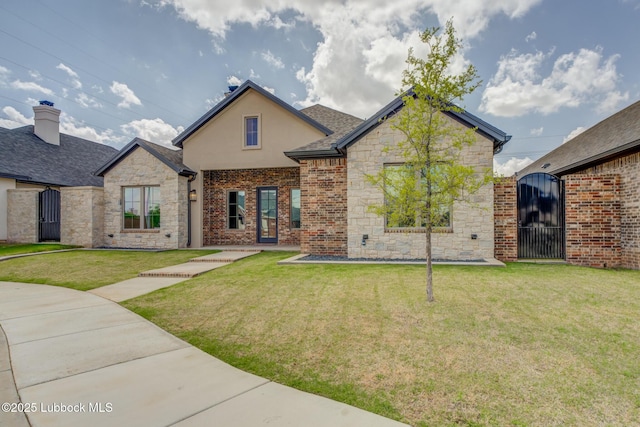 10506 Troy Ave, Lubbock, TX 79424 - view of front of house with stone siding, a gate, a front lawn, and stucco siding