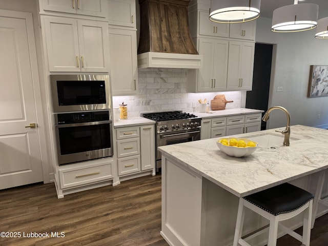 10506 Troy Ave, Lubbock, TX 79424 - kitchen with stainless steel appliances, wall chimney exhaust hood, a sink, dark wood-type flooring, and tasteful backsplash