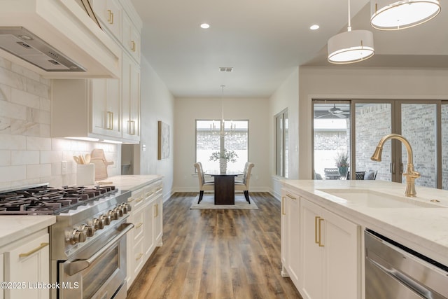 10506 Troy Ave, Lubbock, TX 79424 - kitchen featuring stainless steel appliances, a sink, custom range hood, backsplash, and white cabinets