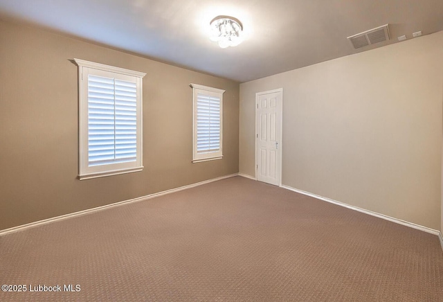 9807 Topeka Ave, Lubbock, TX 79424 - unfurnished room featuring carpet floors, baseboards, and visible vents