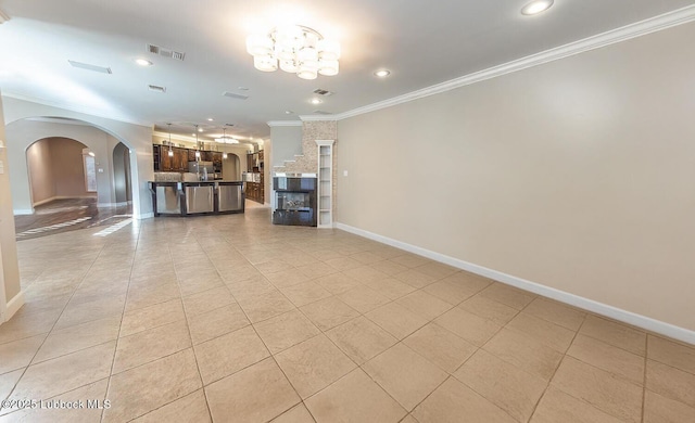 9807 Topeka Ave, Lubbock, TX 79424 - living room with arched walkways, baseboards, ornamental molding, and light tile patterned flooring