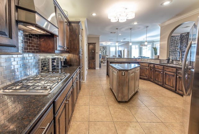 9807 Topeka Ave, Lubbock, TX 79424 - kitchen with crown molding, recessed lighting, a chandelier, tasteful backsplash, and appliances with stainless steel finishes