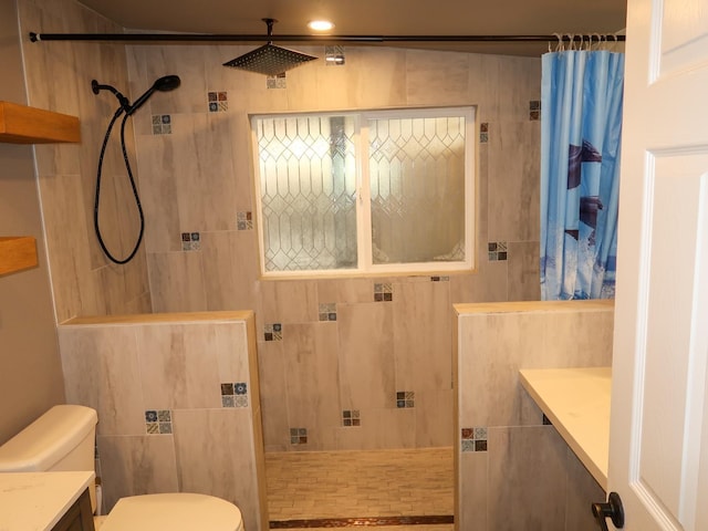 bathroom featuring vanity, curtained shower, and toilet