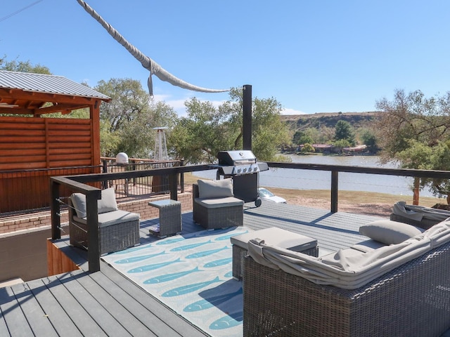 wooden terrace with a water view, area for grilling, and outdoor lounge area