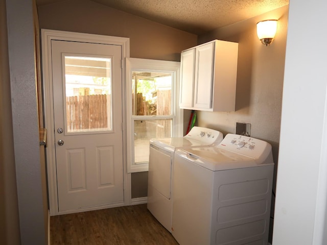 laundry room featuring cabinets, dark hardwood / wood-style floors, a textured ceiling, and independent washer and dryer